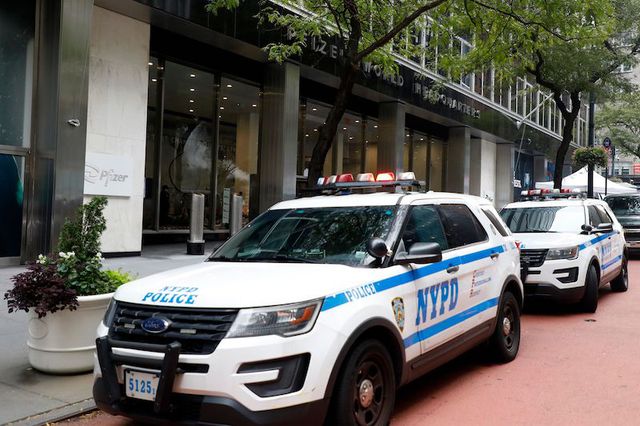 Two New York City Police Department (NYPD) cruisers are seen outside the headquarters of the pharmaceutical company Pfizer in New York.